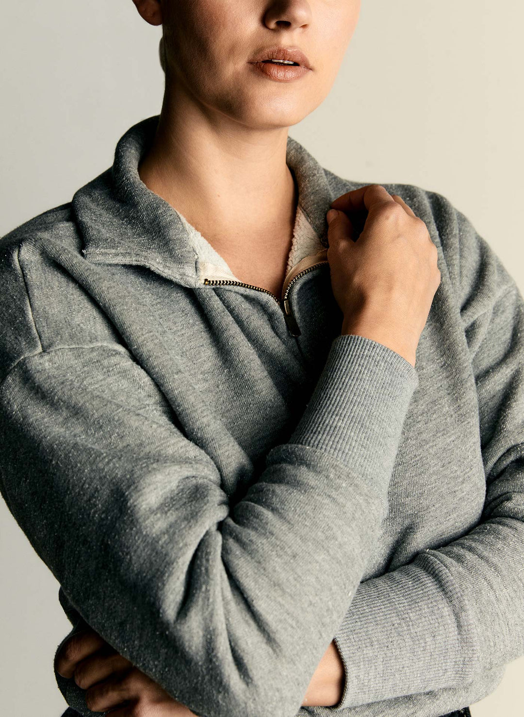 a person wearing a grey sweater