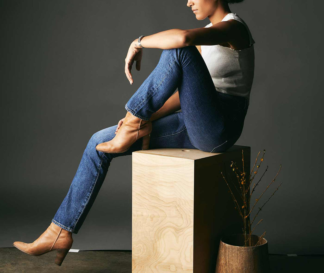a woman sitting on a wooden box