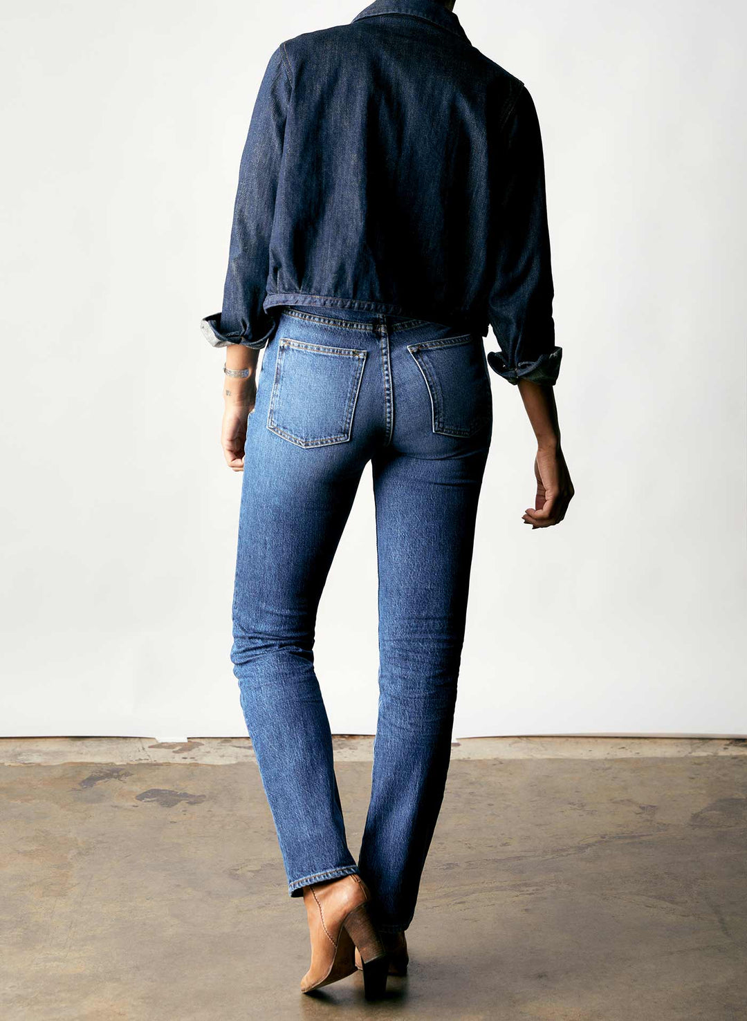 a woman wearing jeans and a blue shirt