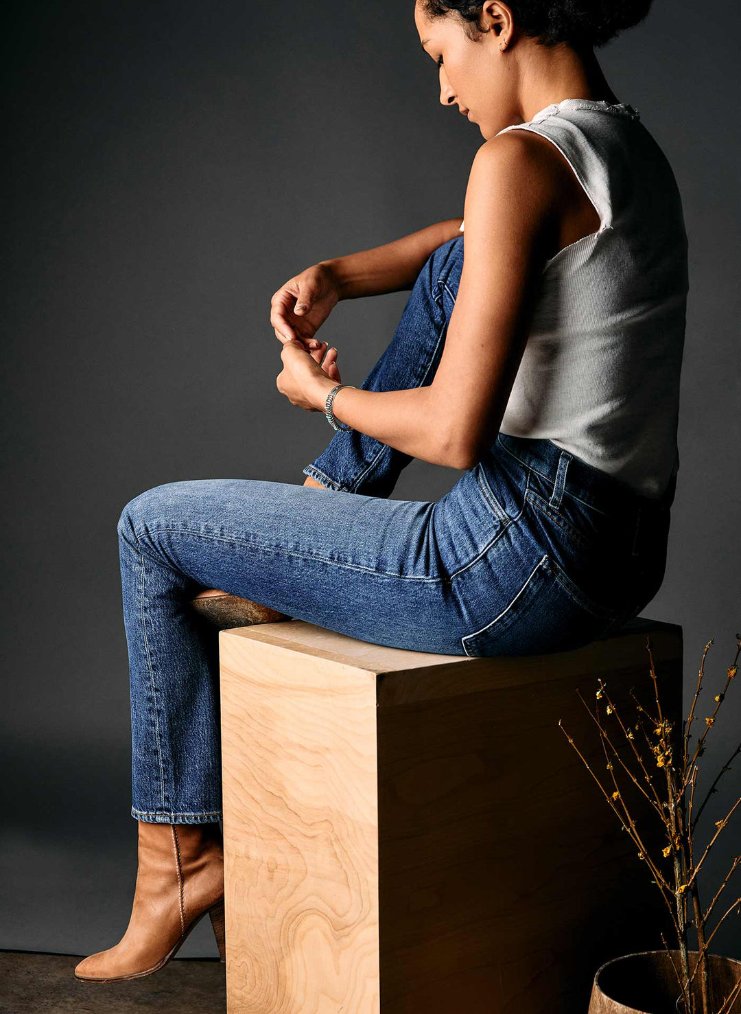 a woman sitting on a wooden box