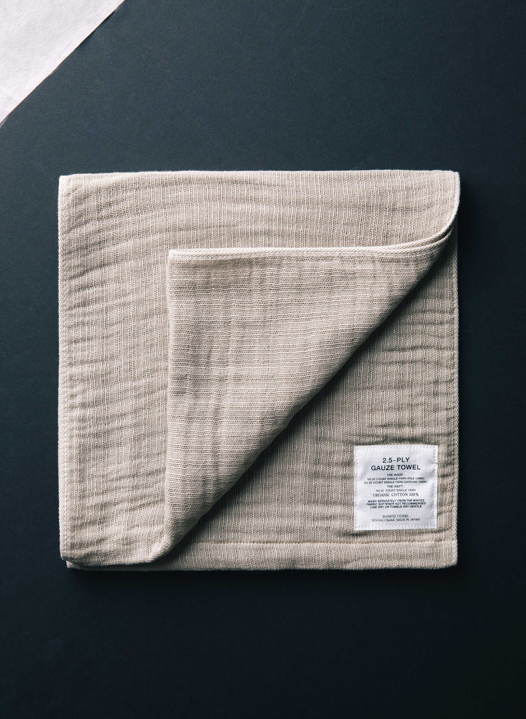 a folded towel on a black surface