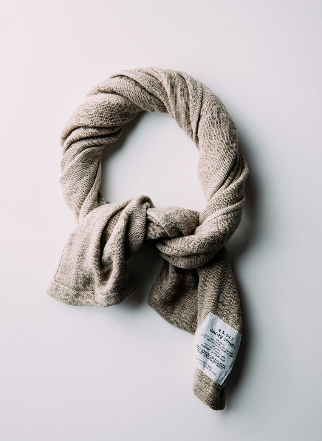 a scarf tied to a white surface